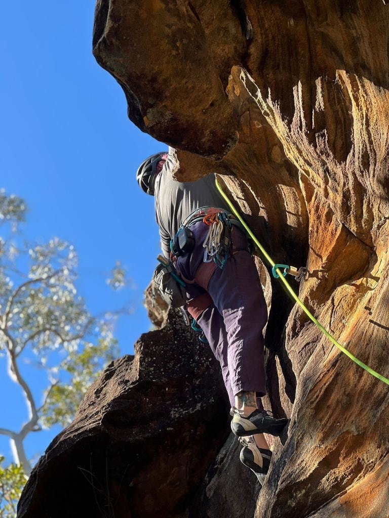 Dr Mara Hickey tackling a sandstone overhang on rope